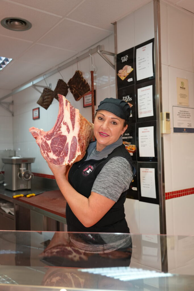 Woman holding large cut of meat
